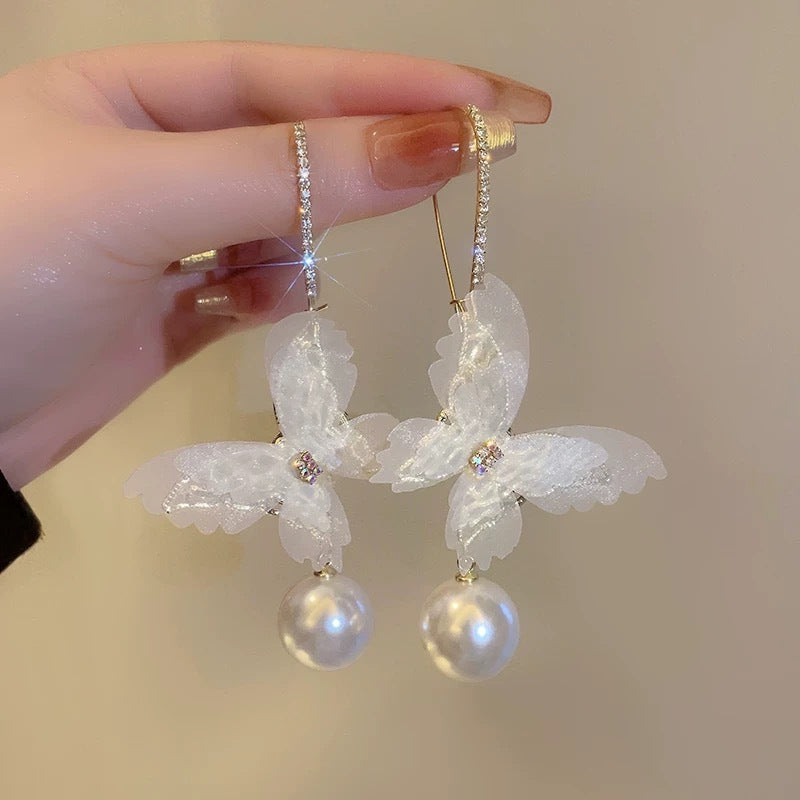 A girl with super fairy-like colorful flower earrings