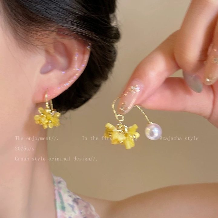 A girl with super fairy-like colorful flower earrings