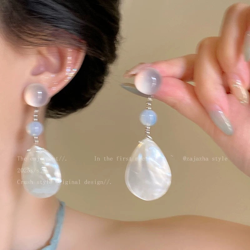 A girl with super fairy-like colorful flower earrings