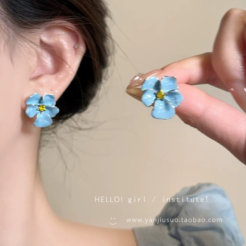 A girl with super fairy-like colorful flower earrings
