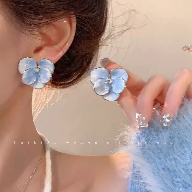 A girl with super fairy-like colorful flower earrings