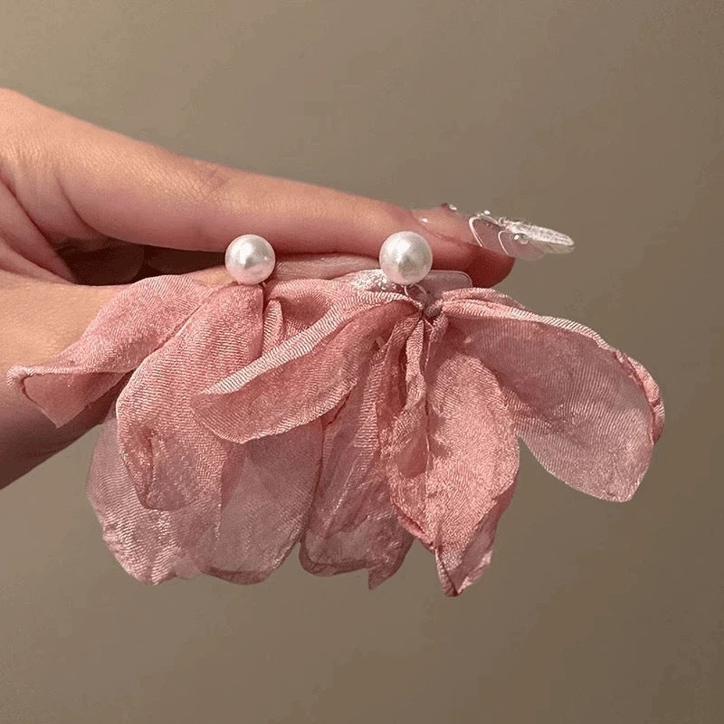 A girl with super fairy-like colorful flower earrings