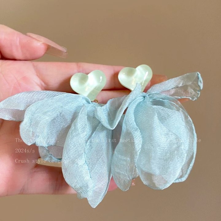 A girl with super fairy-like colorful flower earrings