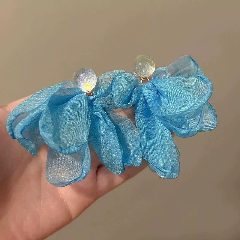 A girl with super fairy-like colorful flower earrings