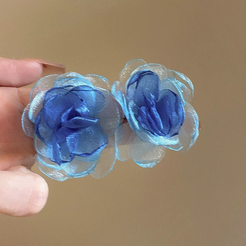 A girl with super fairy-like colorful flower earrings