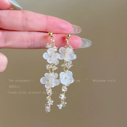 A girl with super fairy-like colorful flower earrings