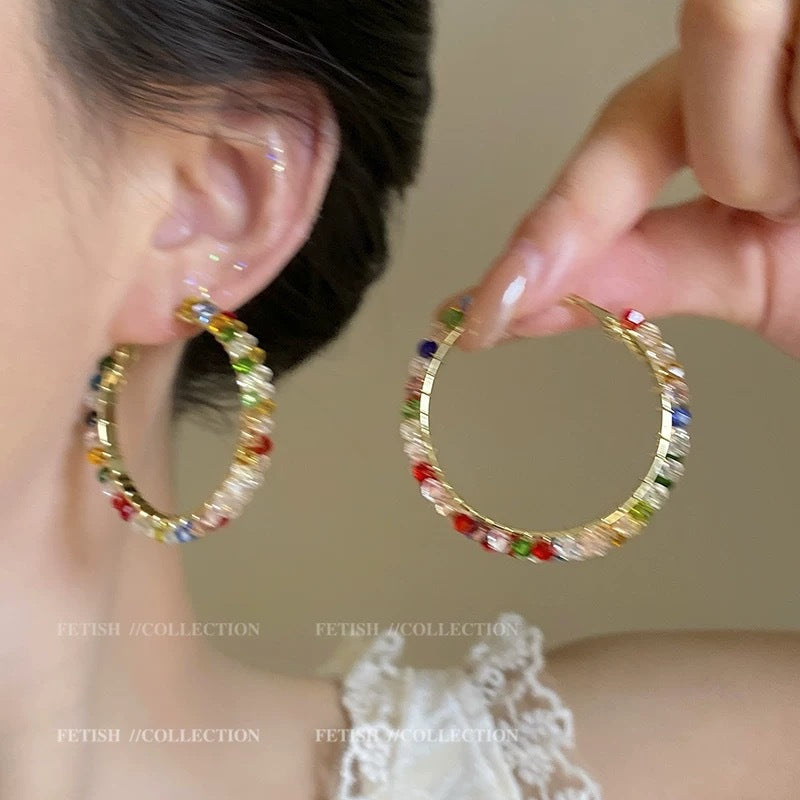 A girl with super fairy-like colorful flower earrings