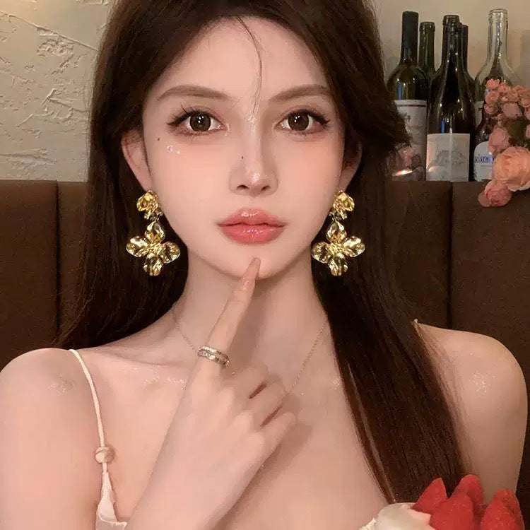 A girl with super fairy-like colorful flower earrings