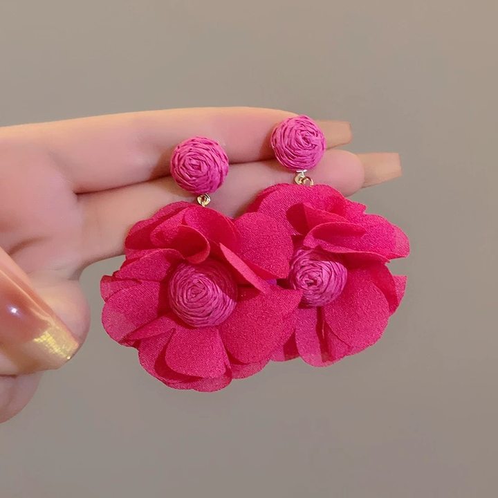 A girl with super fairy-like colorful flower earrings