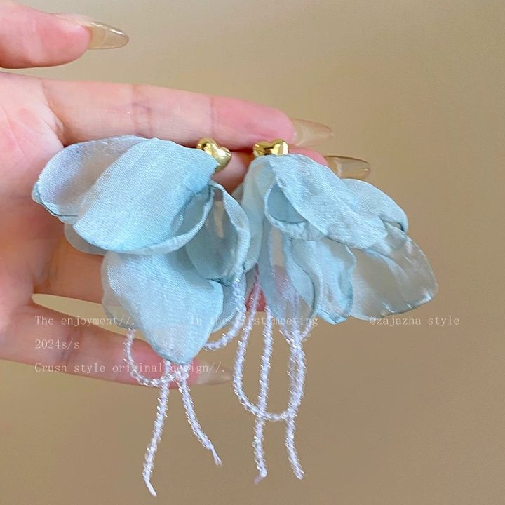 A girl with super fairy-like colorful flower earrings