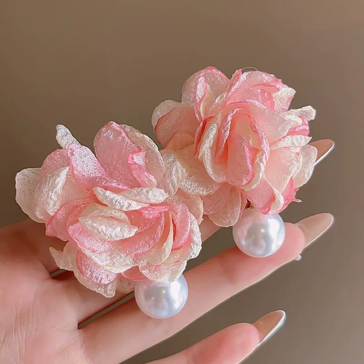 A girl with super fairy-like colorful flower earrings