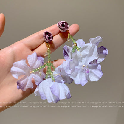 A girl with super fairy-like colorful flower earrings