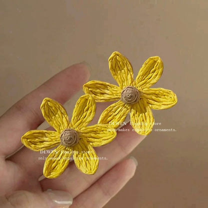 A girl with super fairy-like colorful flower earrings