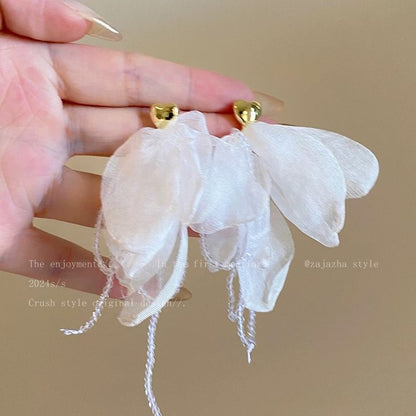 A girl with super fairy-like colorful flower earrings