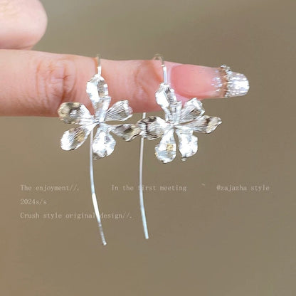 A girl with super fairy-like colorful flower earrings