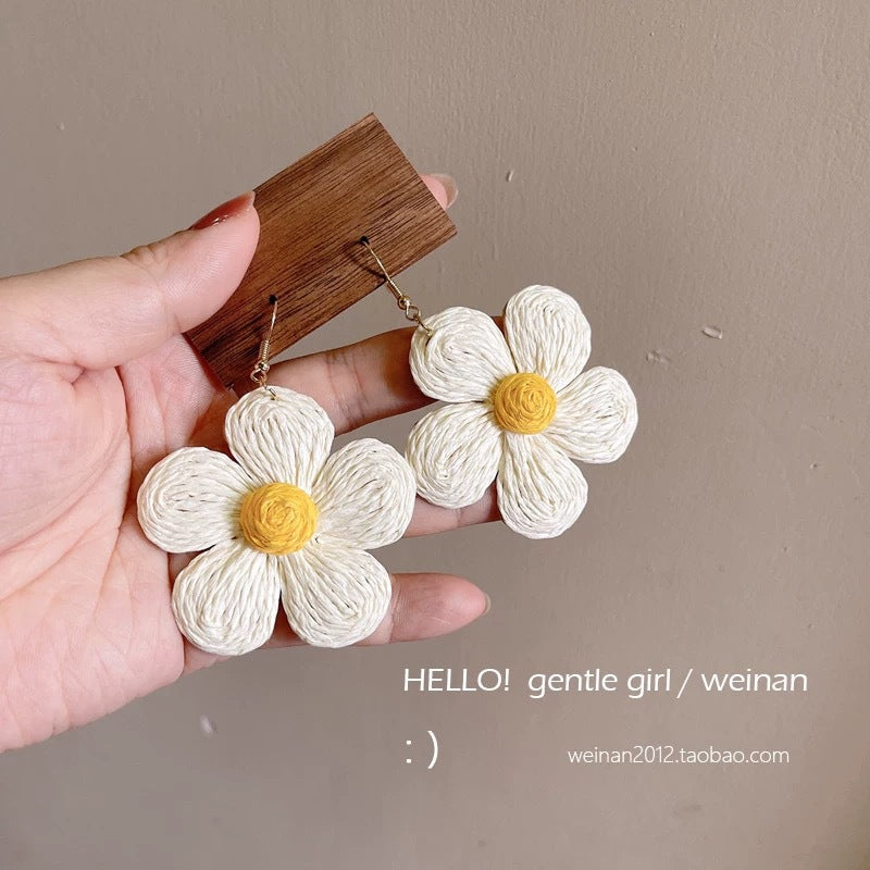 A girl with super fairy-like colorful flower earrings