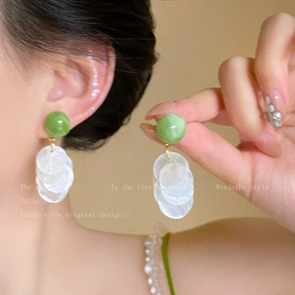 A girl with super fairy-like colorful flower earrings