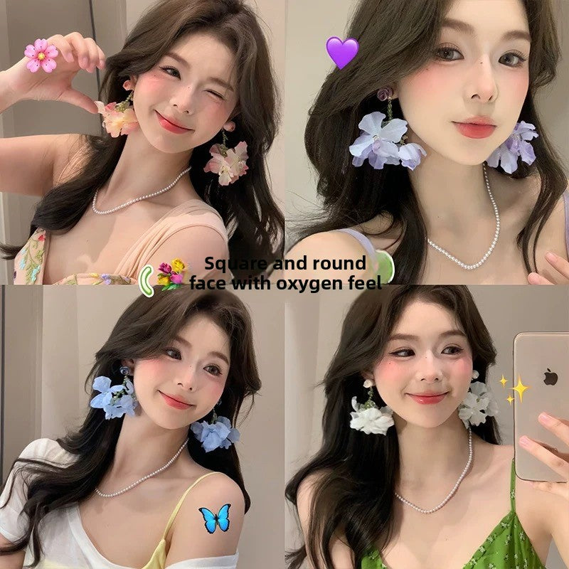 A girl with super fairy-like colorful flower earrings