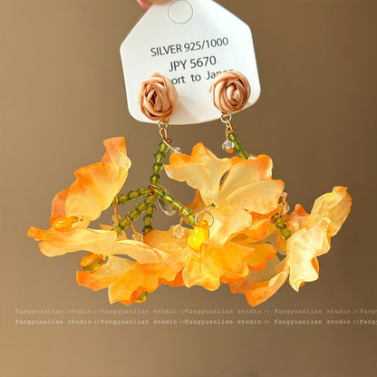 A girl with super fairy-like colorful flower earrings