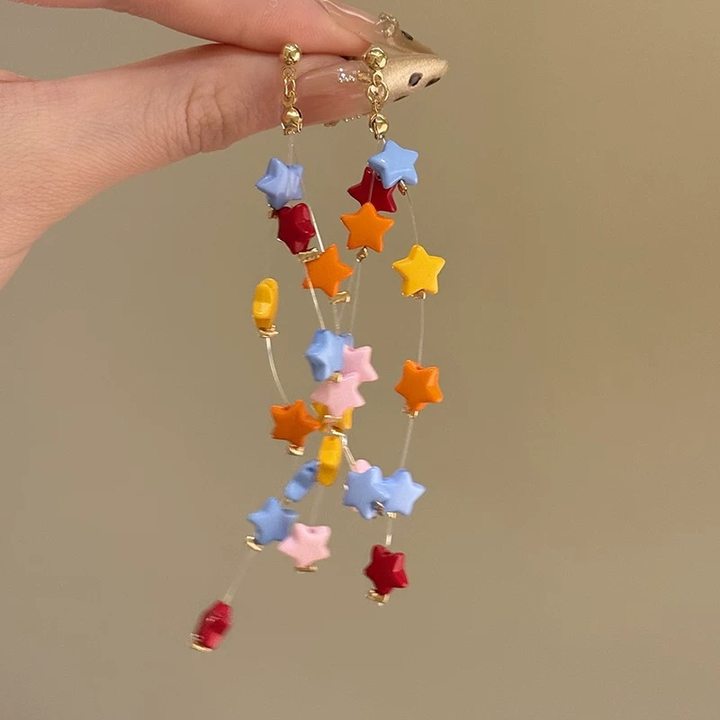 A girl with super fairy-like colorful flower earrings