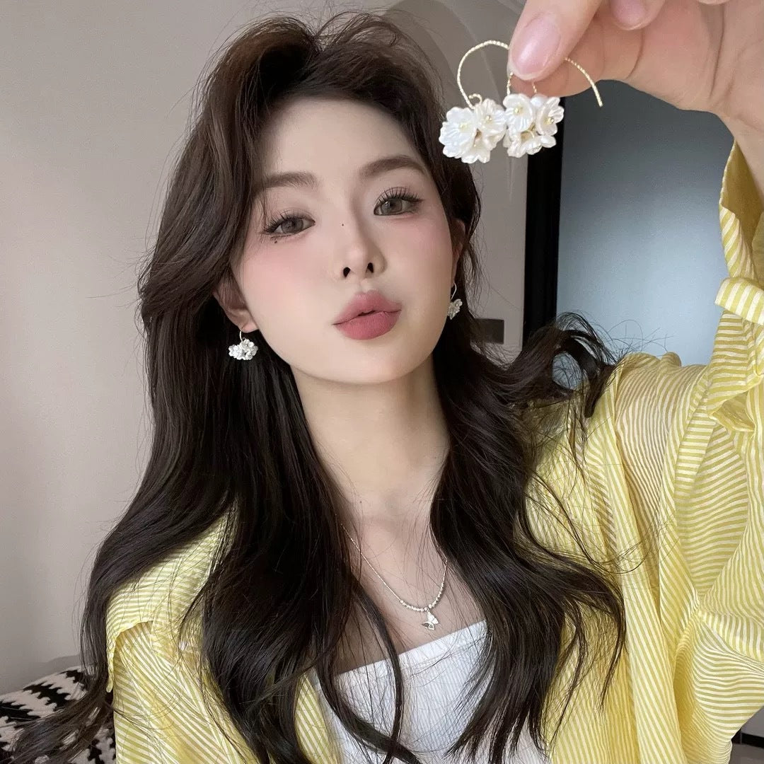 A girl with super fairy-like colorful flower earrings