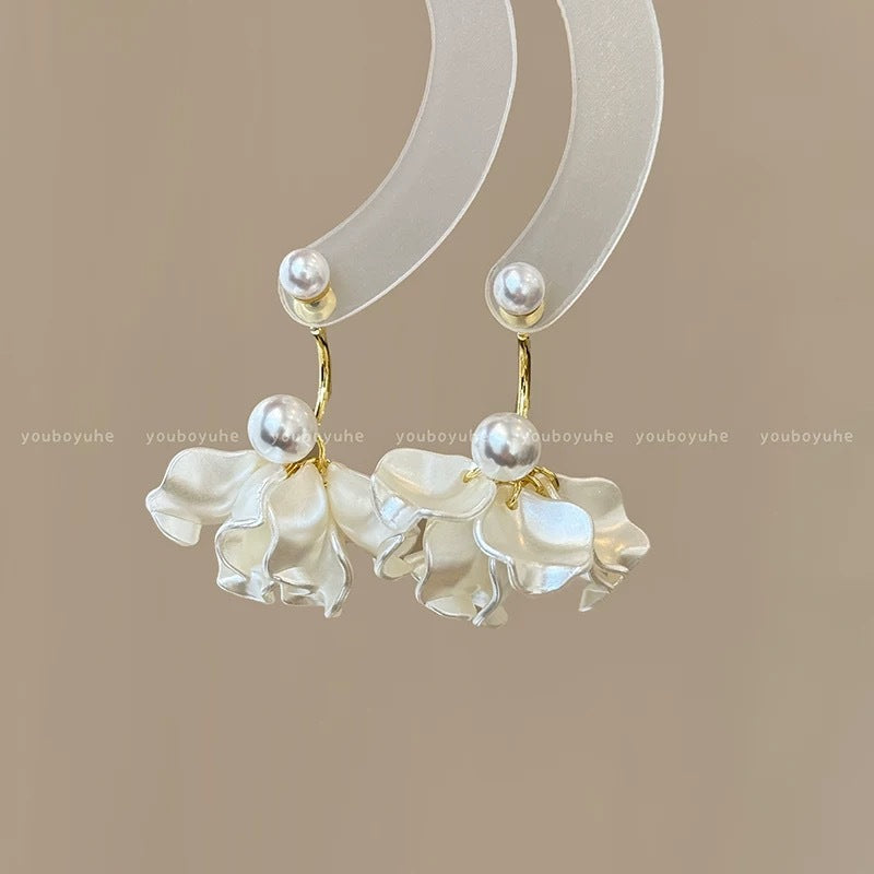 A girl with super fairy-like colorful flower earrings