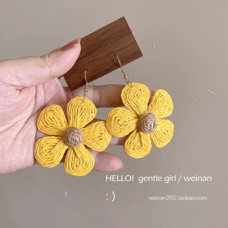 A girl with super fairy-like colorful flower earrings