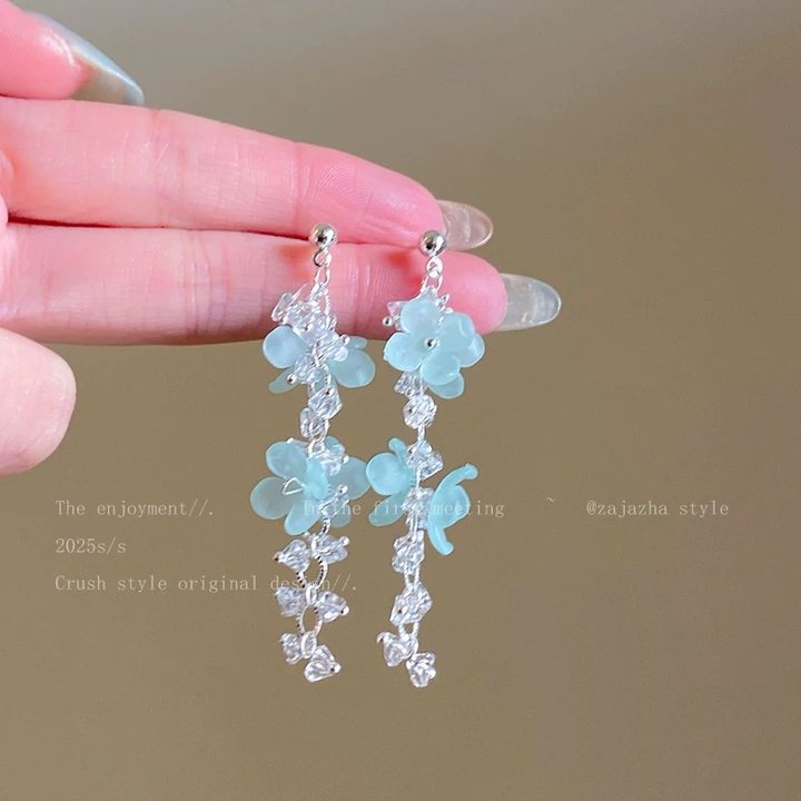 A girl with super fairy-like colorful flower earrings