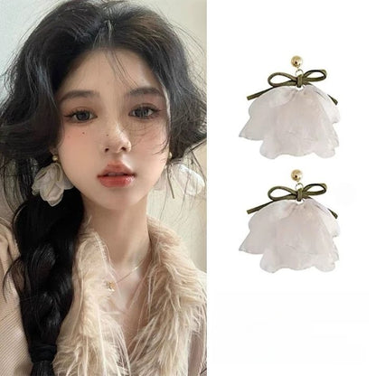 A girl with super fairy-like colorful flower earrings