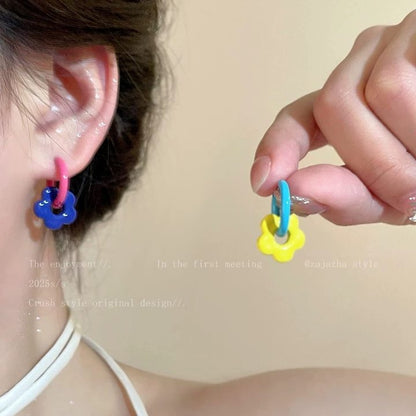 A girl with super fairy-like colorful flower earrings