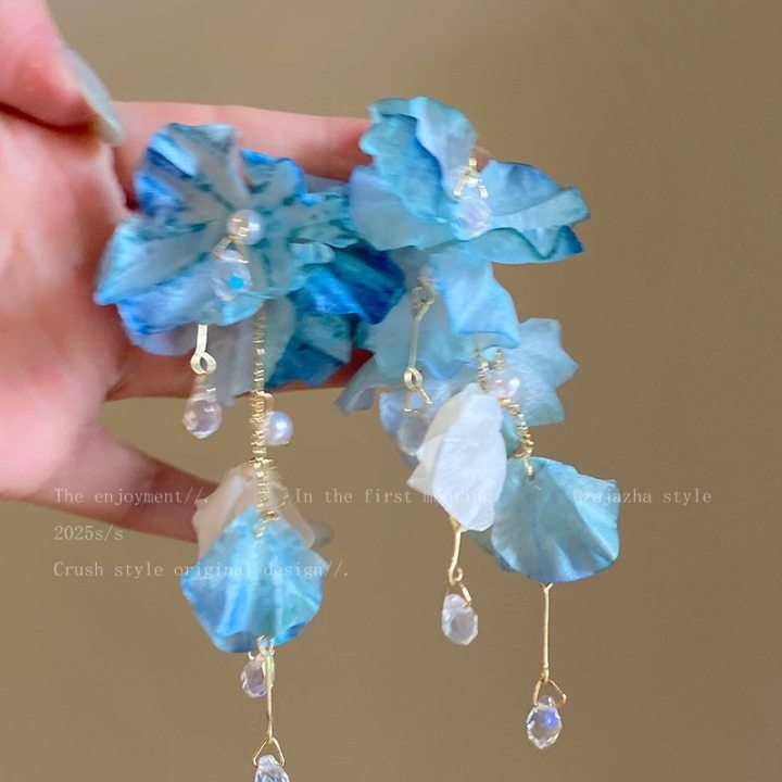A girl with super fairy-like colorful flower earrings