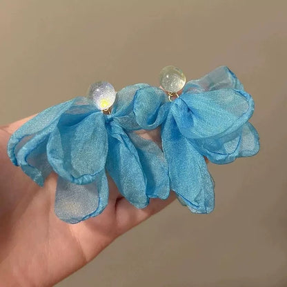 A girl with super fairy-like colorful flower earrings
