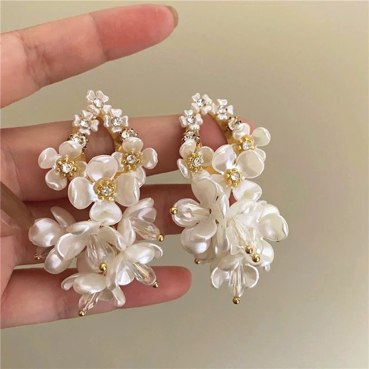 A girl with super fairy-like colorful flower earrings