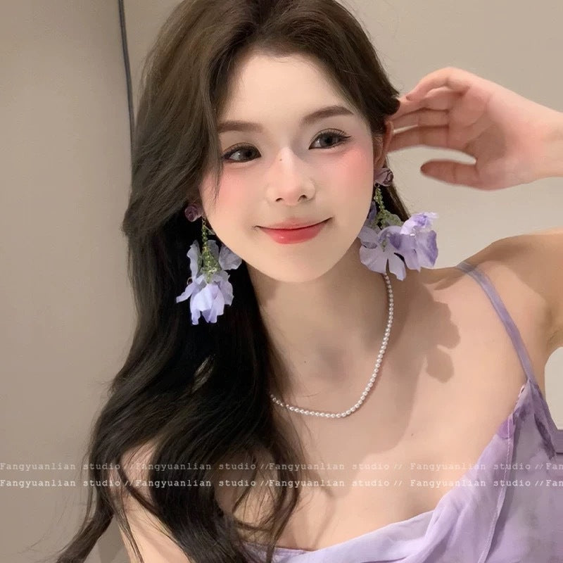 A girl with super fairy-like colorful flower earrings