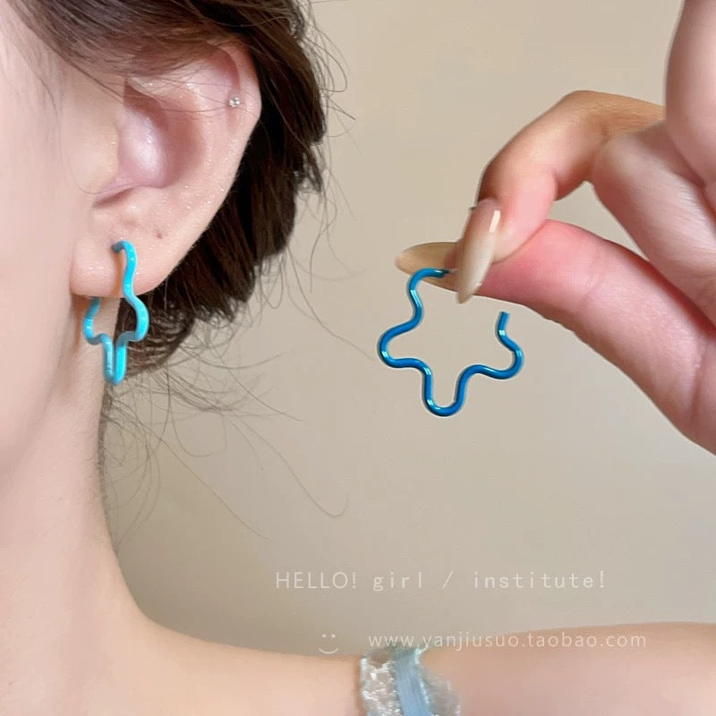 A girl with super fairy-like colorful flower earrings