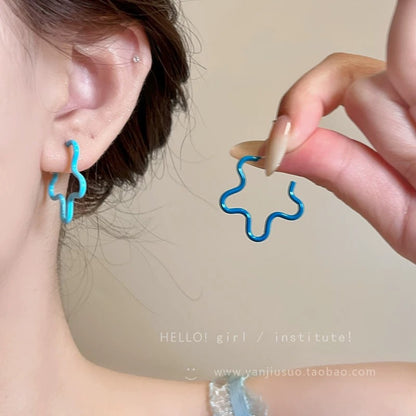 A girl with super fairy-like colorful flower earrings