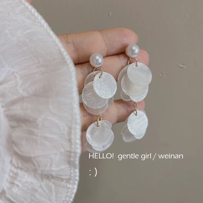 A girl with super fairy-like colorful flower earrings