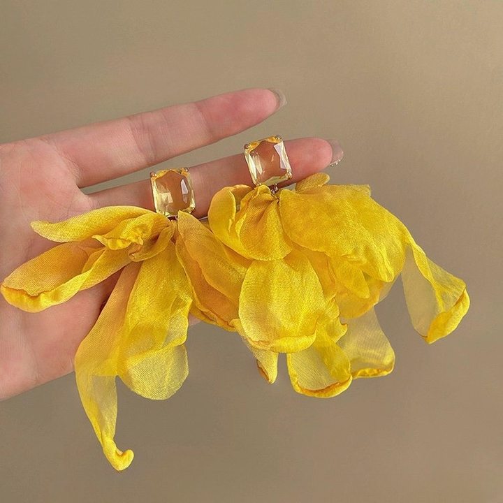 A girl with super fairy-like colorful flower earrings