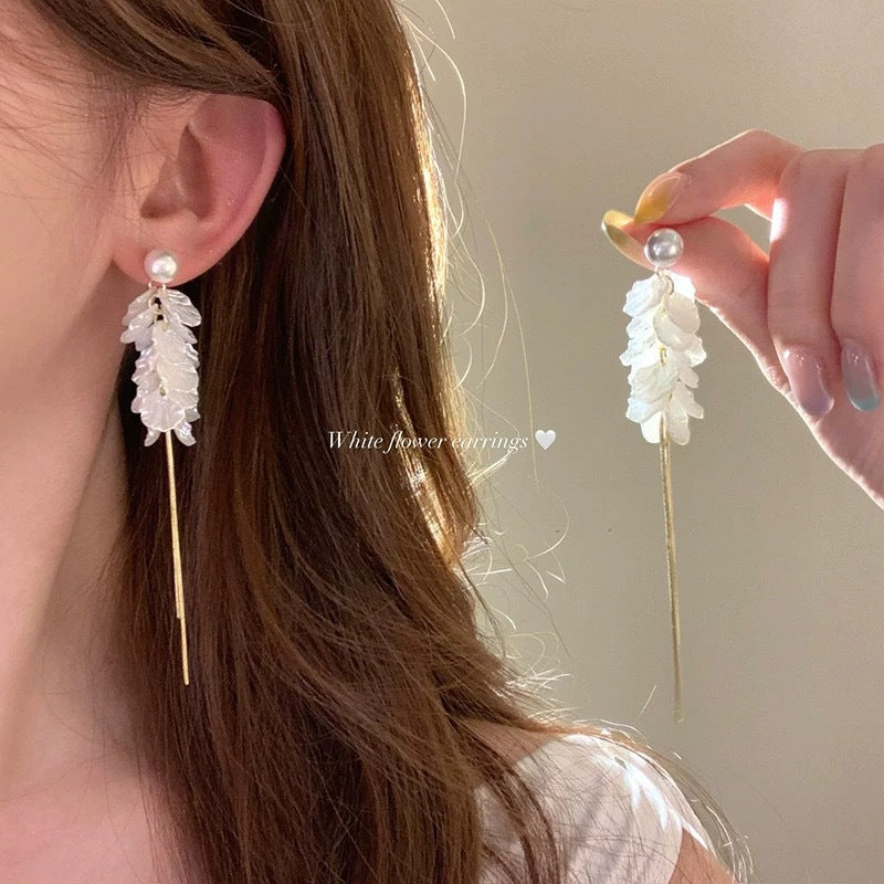 A girl with super fairy-like colorful flower earrings