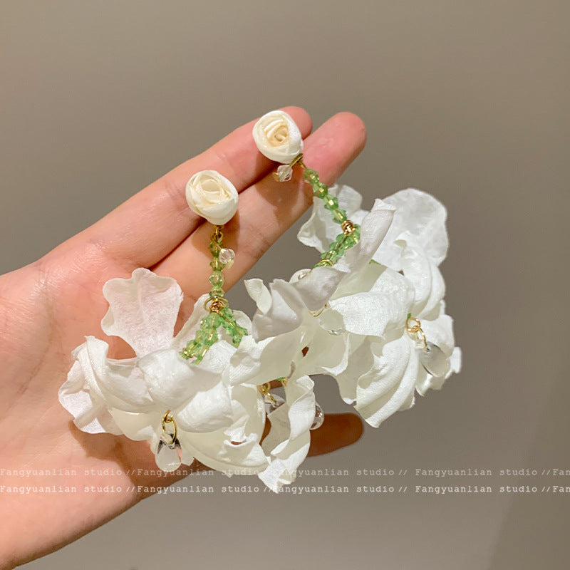 A girl with super fairy-like colorful flower earrings