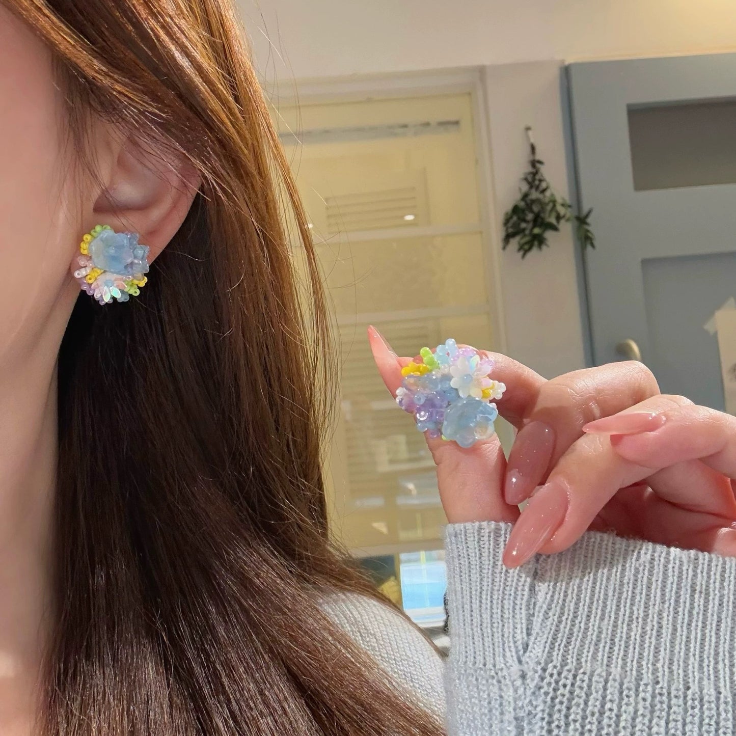 A girl with super fairy-like colorful flower earrings
